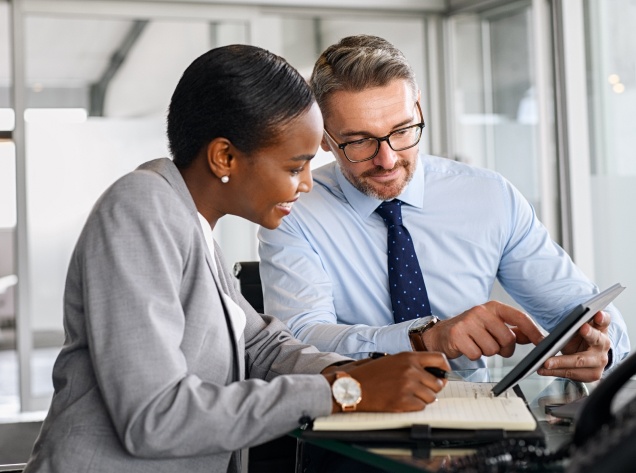 man and woman looking at tablet