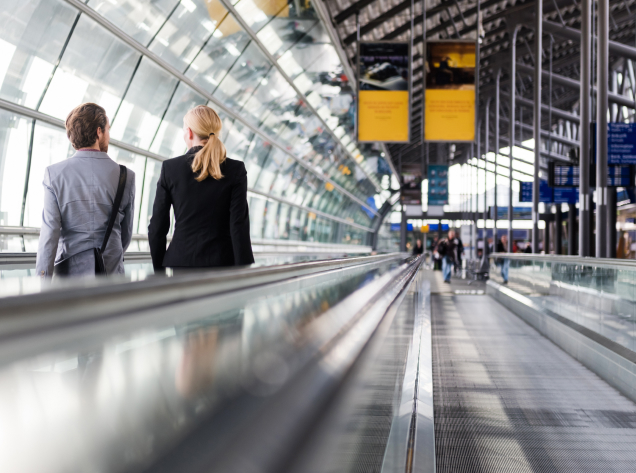 man and woman walking in airport