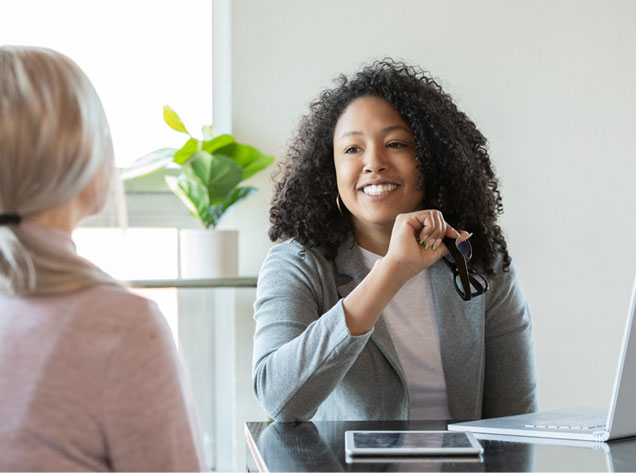two women sitting at desk